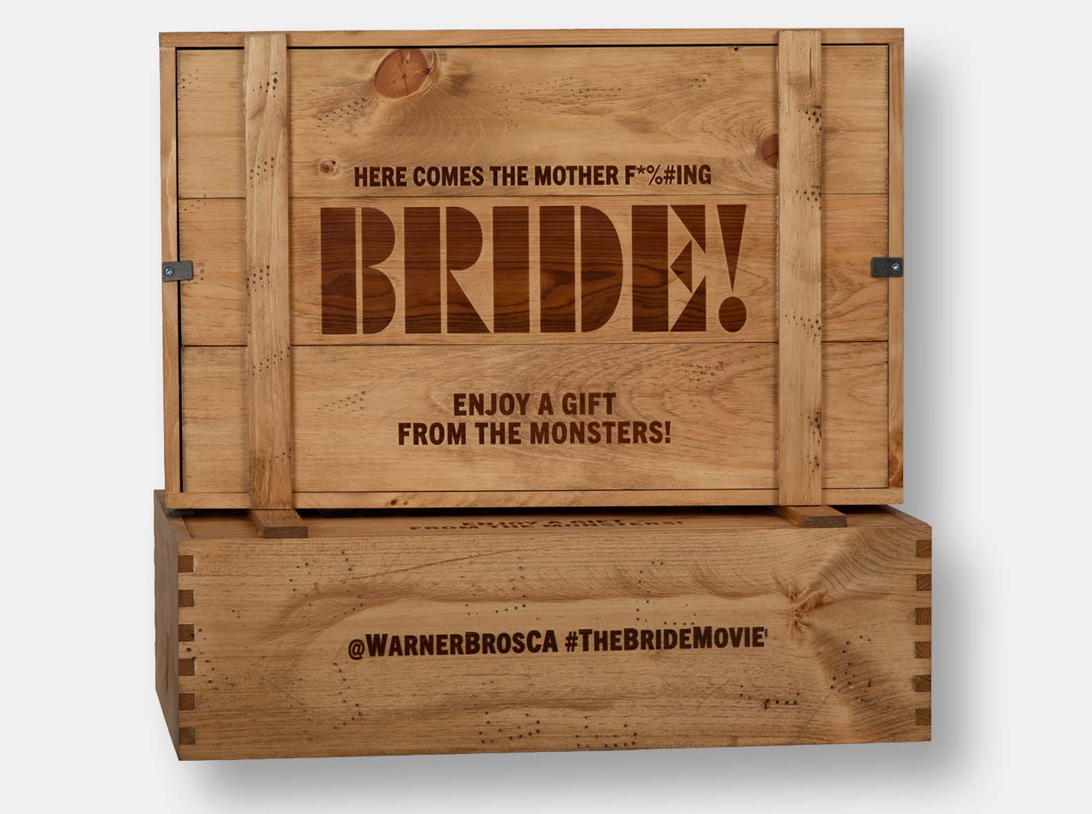 Pine crate with inset lid. Distressed detail and hand-rubbed antique pine oil finish. Pewter metal twists. Wood imprint branding in multiple locations. Box joint construction.